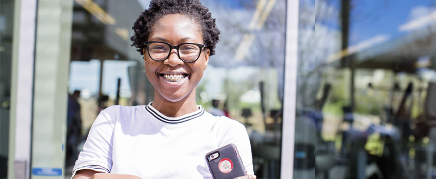 UC Merced undergraduate smiling at photographer on campus